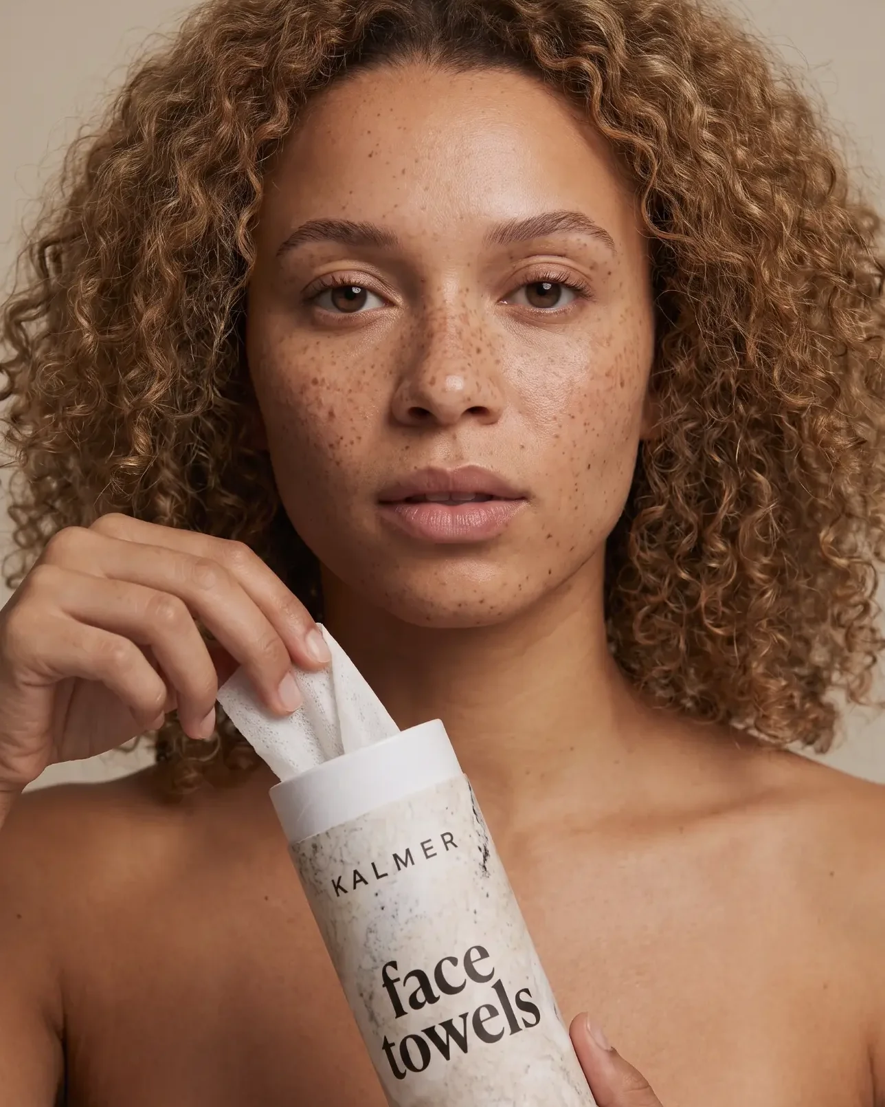Woman holding a KALMER face towels roll